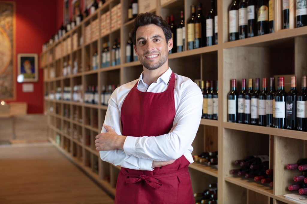 vineyard owner standing in their wine shop