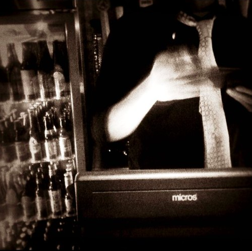 BAr person checking IDs in Black and White moody filter